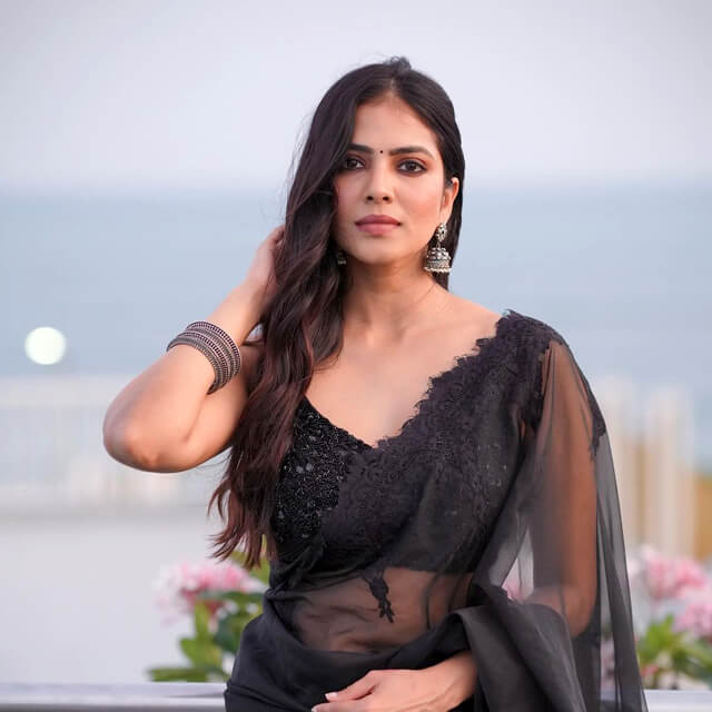 Malavika steps in style wearing a Black Saree at Rohini College