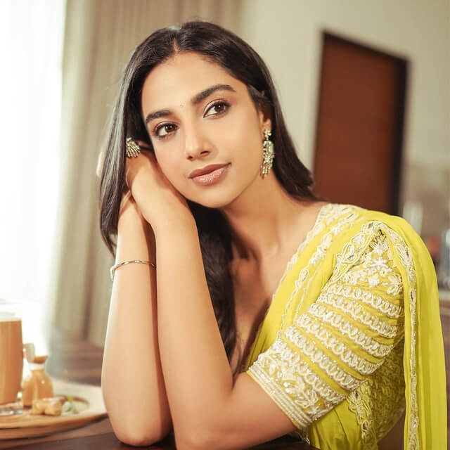 Meenakshi radiates grace in Yellow Saree with White Embroidered Border