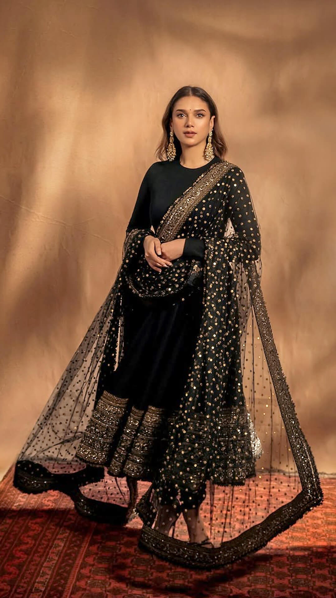 Aditi Rao Hydari's Recent Photoshoot - Aditi exudes grace with the sheer black dupatta featuring golden polka-dot accents and heavily embellished border draped over her shoulder.