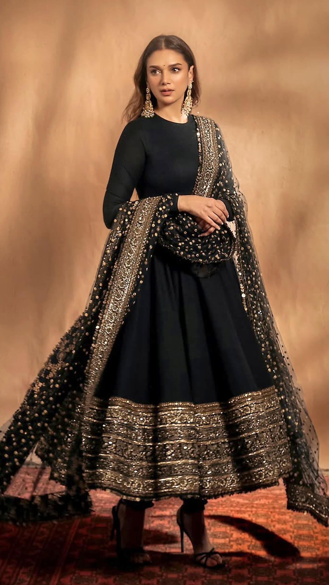 Aditi Rao Hydari's Recent Photoshoot - Aditi's Black Anarkali suit featured intricate gold and silver threadwork on the hemline. The craftsmanship shines through with precision and elegance.