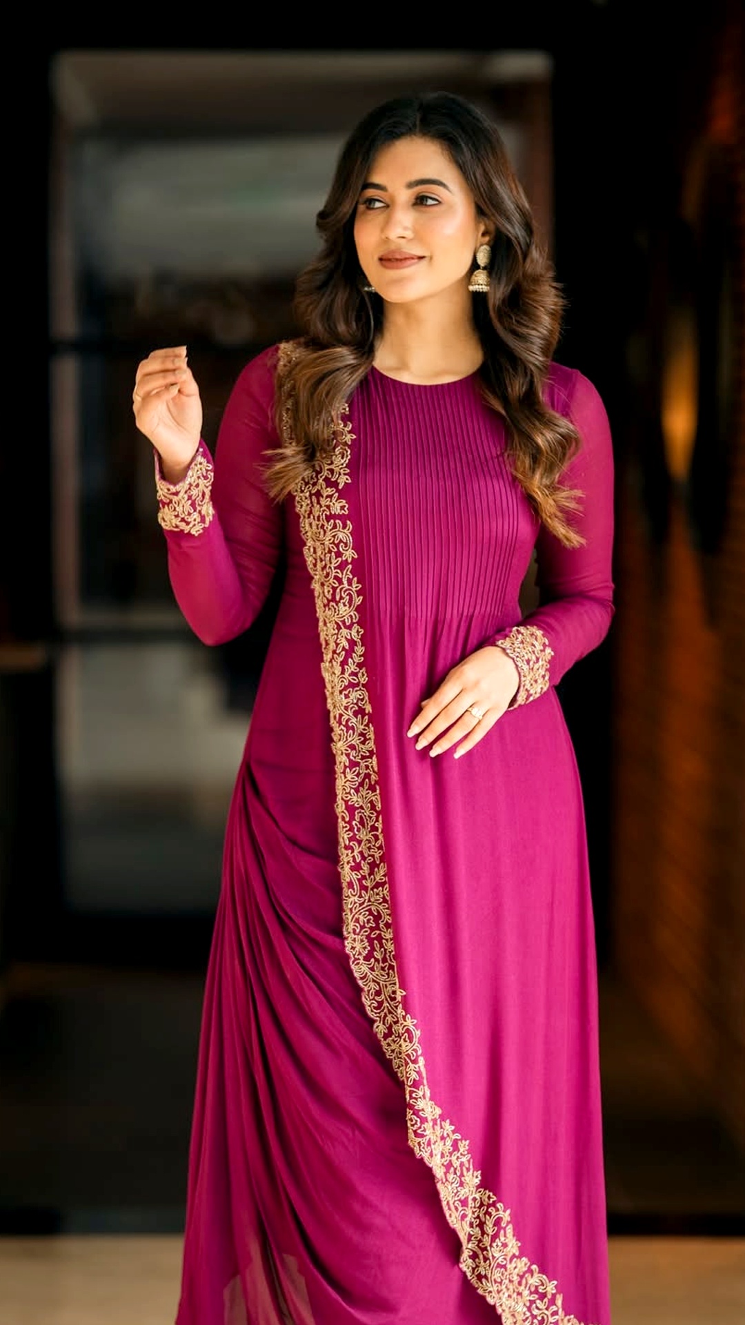 Anju Kurian's Recent Photoshoot - Dressed in a rich magenta anarkali suit with striking gold floral embroidery cascading down the side, she perfectly blends vibrancy with tradition.