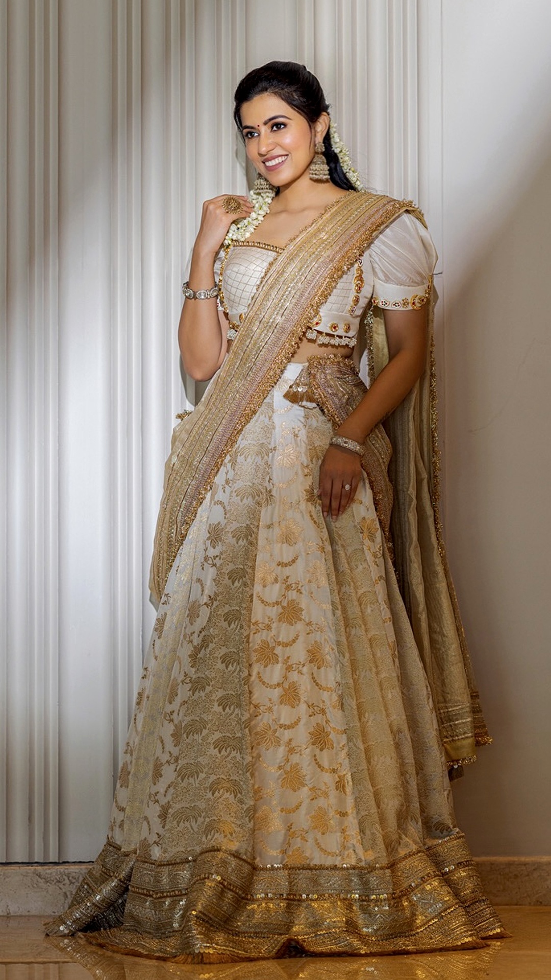 Anju Kurian's Recent Photoshoot - A vision in tradition, she shines in a white and gold Kasavu-style lehenga adorned with intricate embroidery and fresh jasmine garlands.