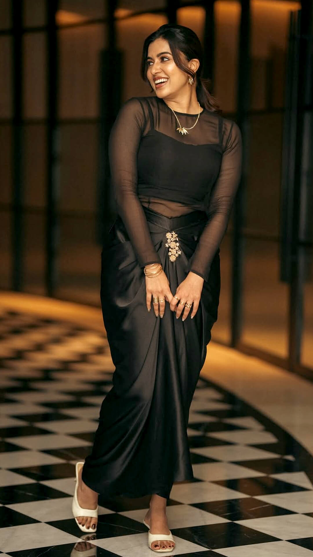 Anju Kurian's Recent Photoshoot - Anju Kurian's outfit by Thunnal blends tradition with trend, pairing a sleek draped skirt with a modern sheer blouse for an effortlessly elegant appeal.