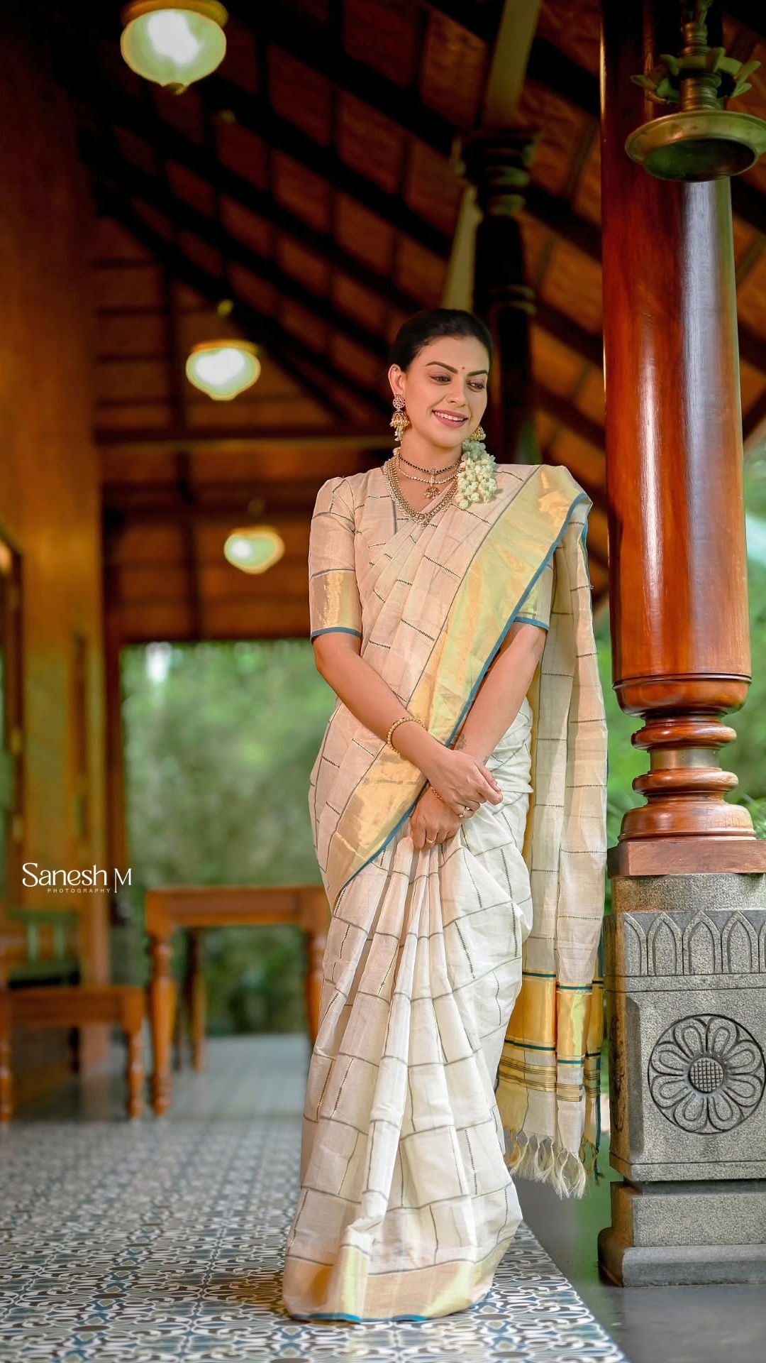 Anusree Nair's Recent Photoshoot - A matching half-sleeve blouse echoes the saree's woven character instead of competing with it. The coordinated styling keeps the outfit visually unified.