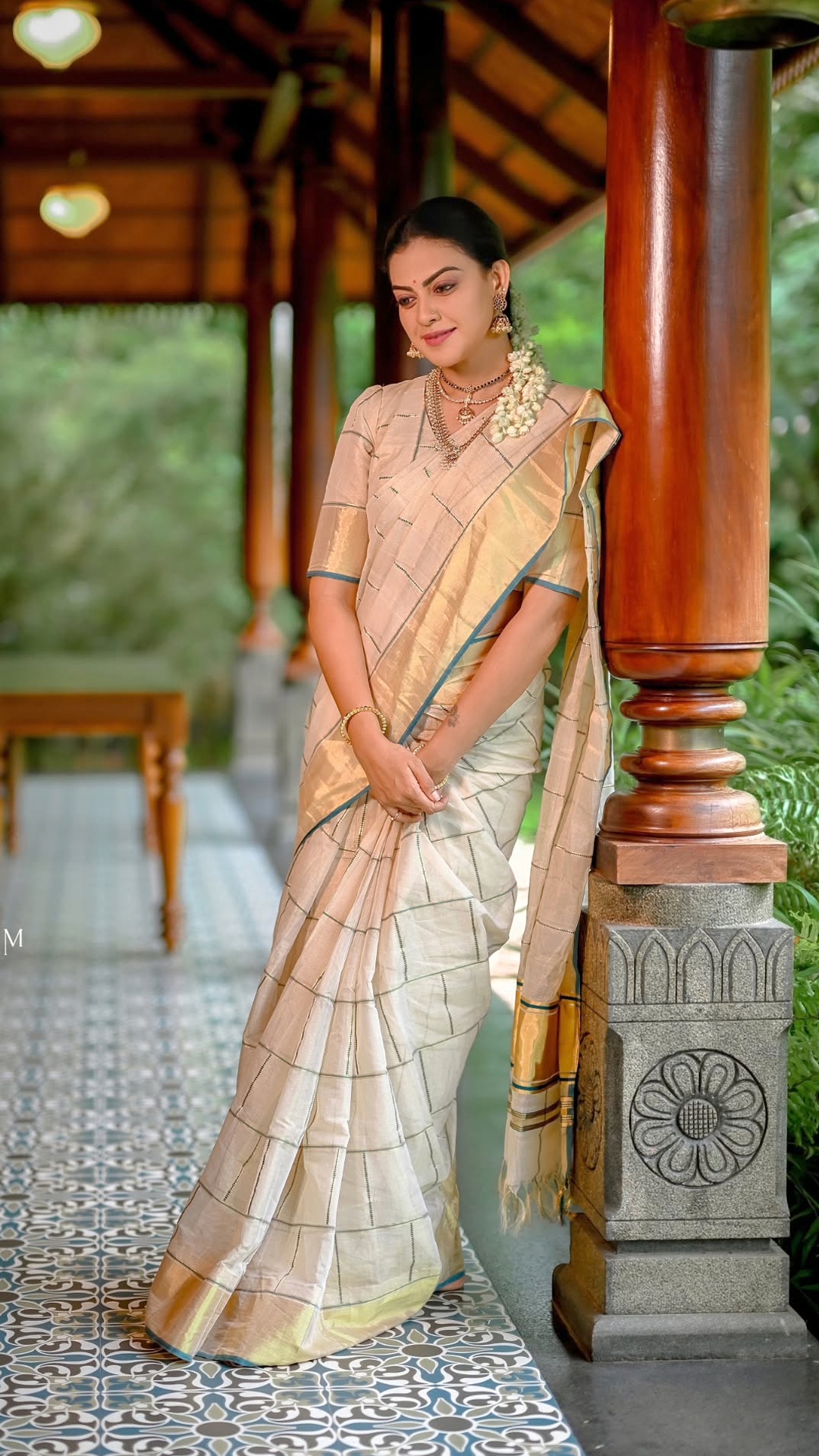 Anusree Nair's Recent Photoshoot - Hair by Pinky Visal is gathered into a sleek bun decorated with jasmine flowers, reflecting Anusree's caption, 'Forever a sari girl at heart.'