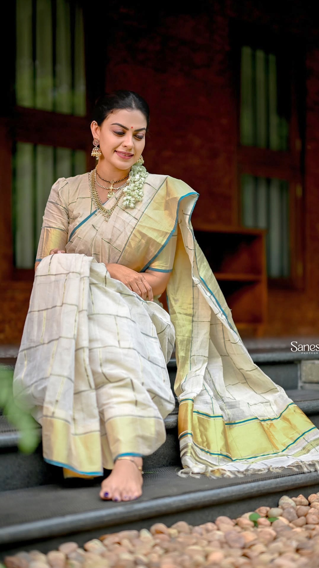 Anusree Nair's Recent Photoshoot - Photographed by Sanesh M at Kanavu, natural surroundings and warm wooden architecture bring depth without drawing attention away from the saree.