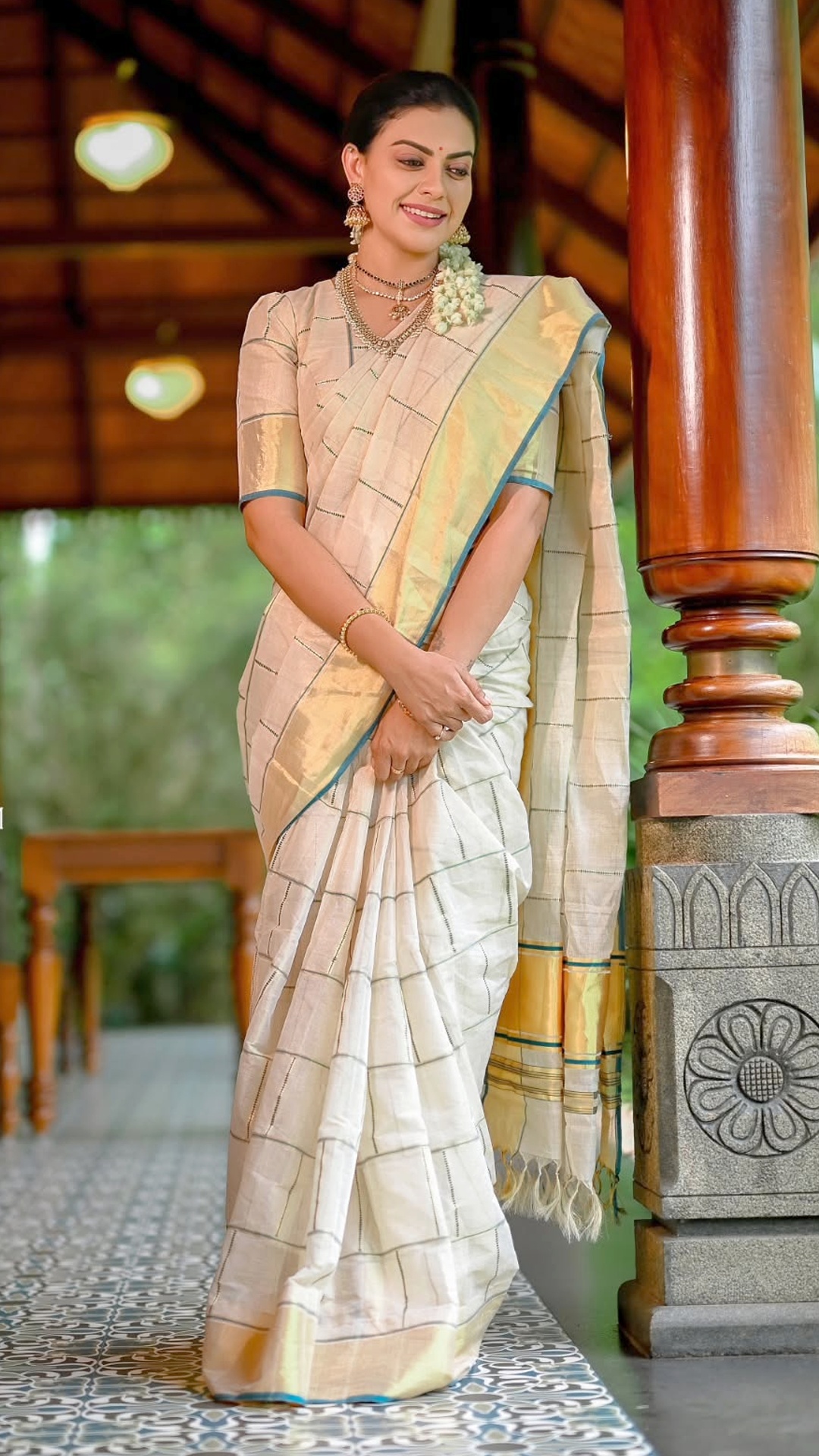 Anusree Nair's Recent Photoshoot - From Pichakam Handlooms, the saree pairs a fine checked body with a broad golden border. Its restrained detailing keeps the weave at the centre of attention.