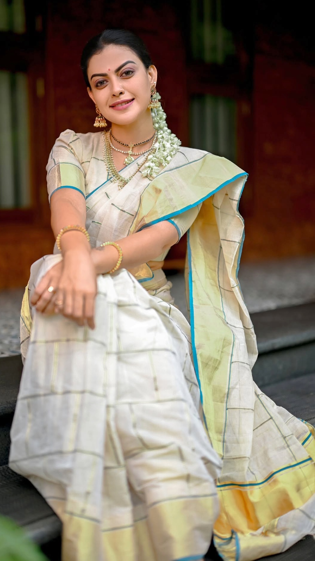 Anusree Nair's Recent Photoshoot - The simple round neckline leaves room for layered necklaces to remain visible while preserving the outfit's clean proportions.