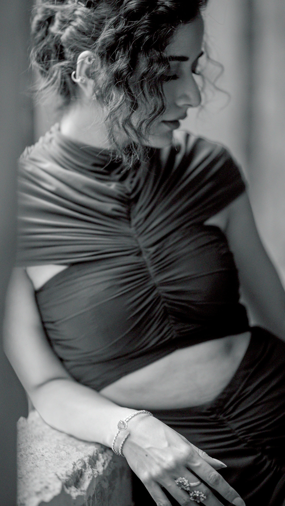 Ashika Ranganath's Recent Photoshoot - The high, gathered neckline stands in contrast to the bare cutouts below it, giving the gown a controlled, architectural finish.