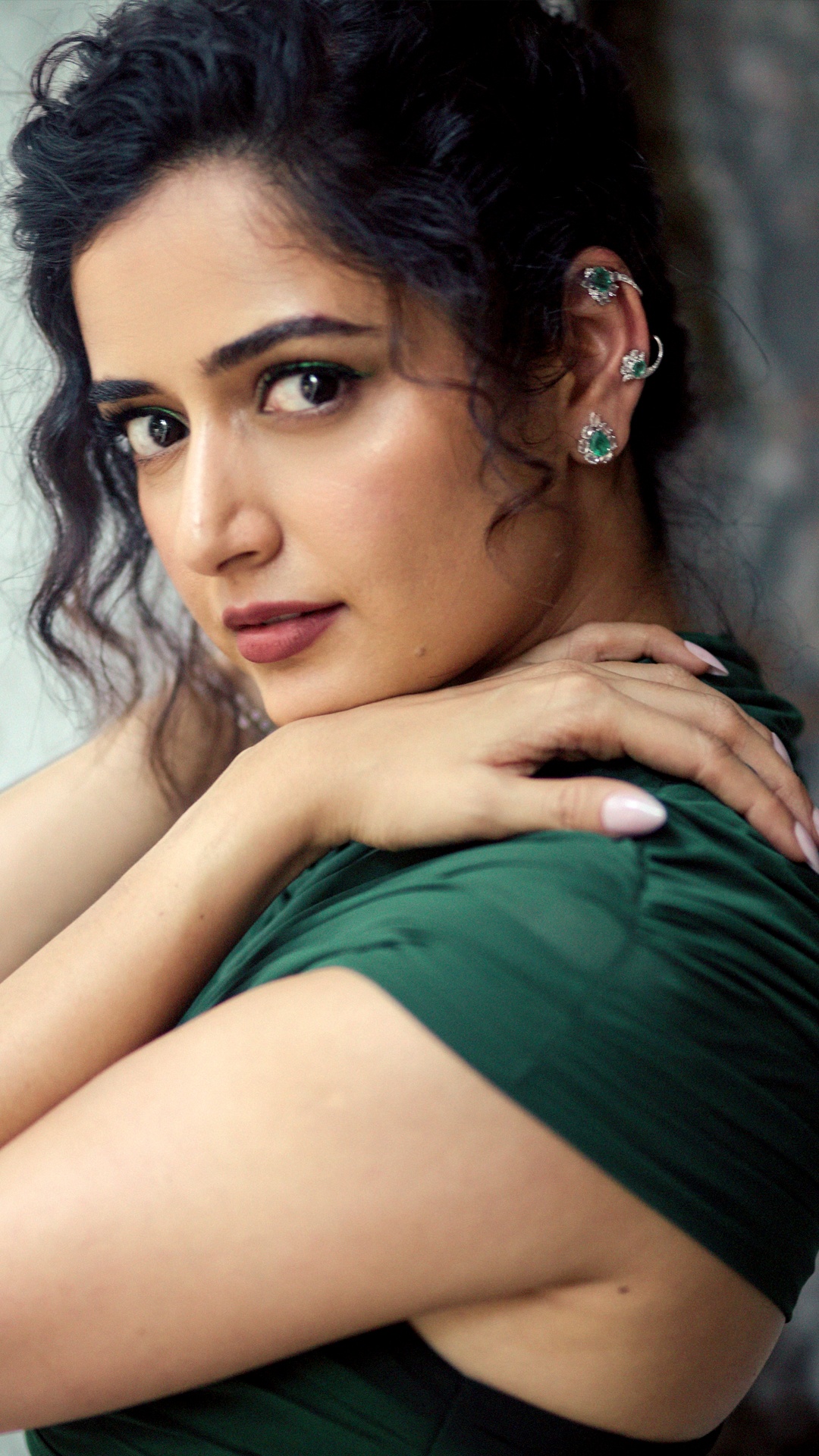 Ashika Ranganath's Recent Photoshoot - An emerald-studded ear cuff climbs the ear, paired with a matching bracelet and rings from Kathaa by Konika, echoing the gown's colour.