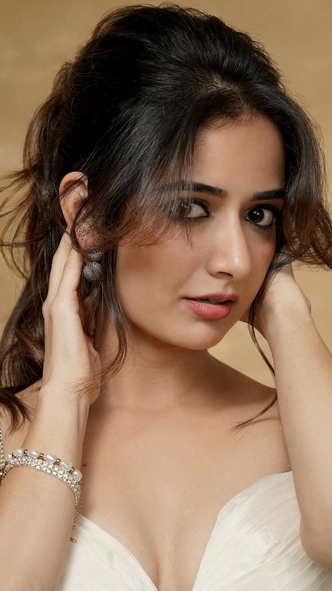 Ashika Ranganath's Recent Photoshoot - Paramesh Kammari styled her hair in a chic low ponytail with soft waves and face-framing strands.