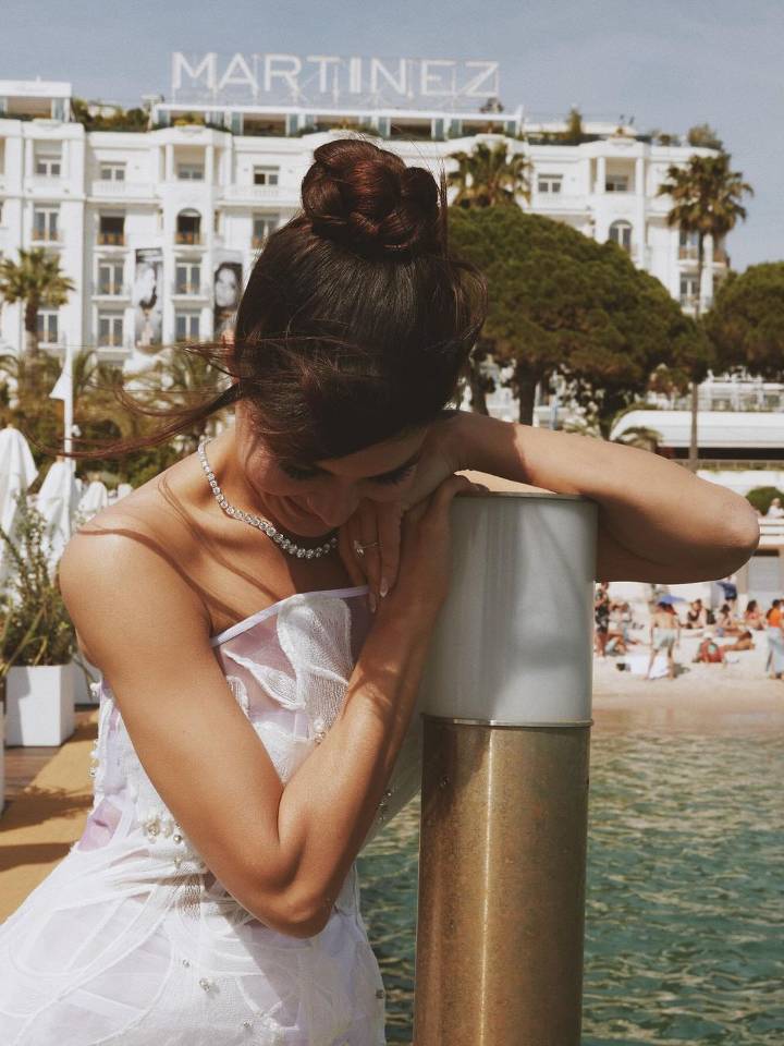 Jacqueline Fernandez's Recent Photoshoot - Styled by Shaan Muttathil, Jacqueline's sleek high bun with fringes and loose strands perfectly complements her elegant look at Cannes.