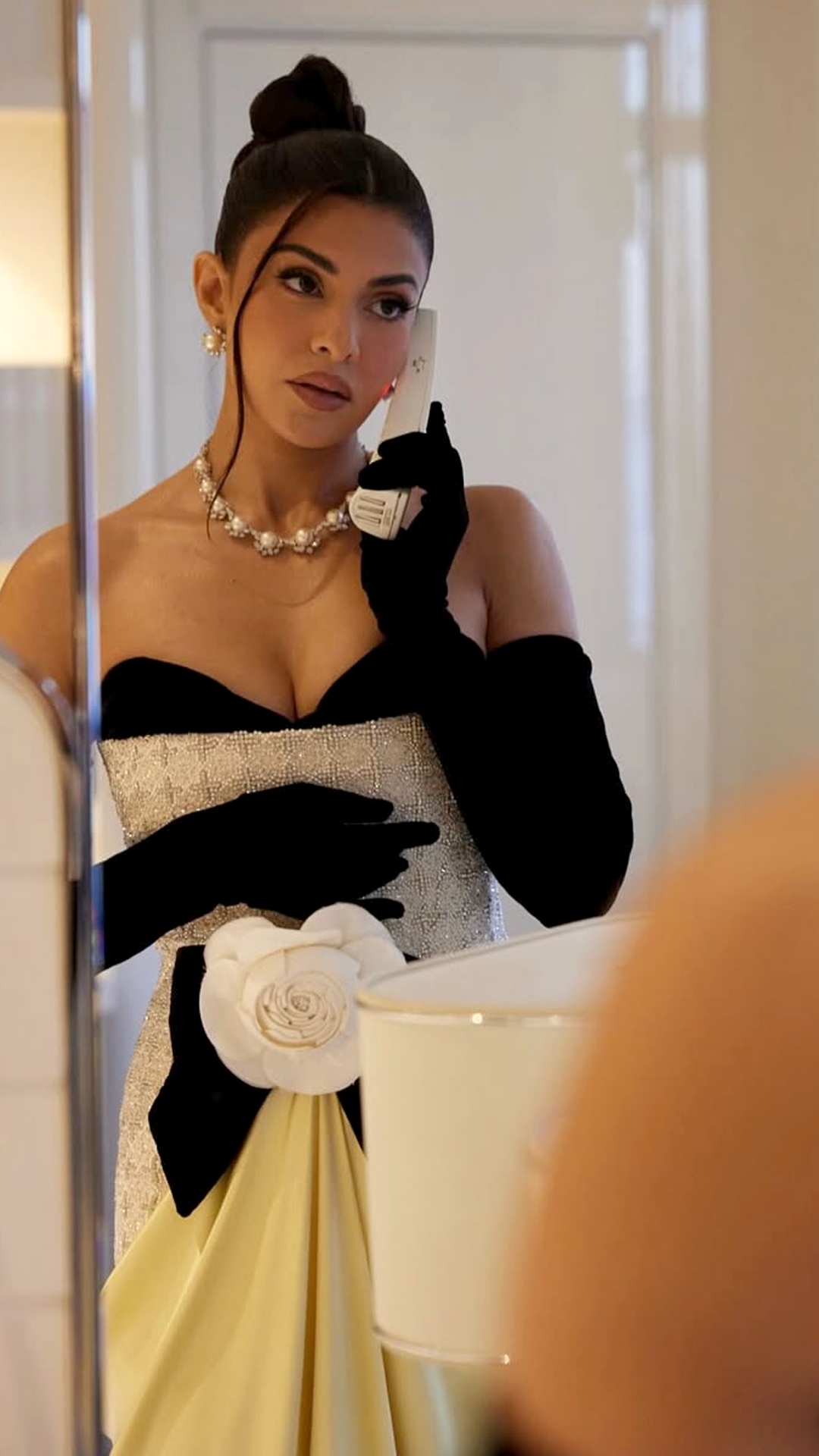 Jacqueline Fernandez's Recent Photoshoot - An ivory-toned bodice with a black neckline and waist accent. It features a dense, heavily beaded surface texture and shiny metallic details.