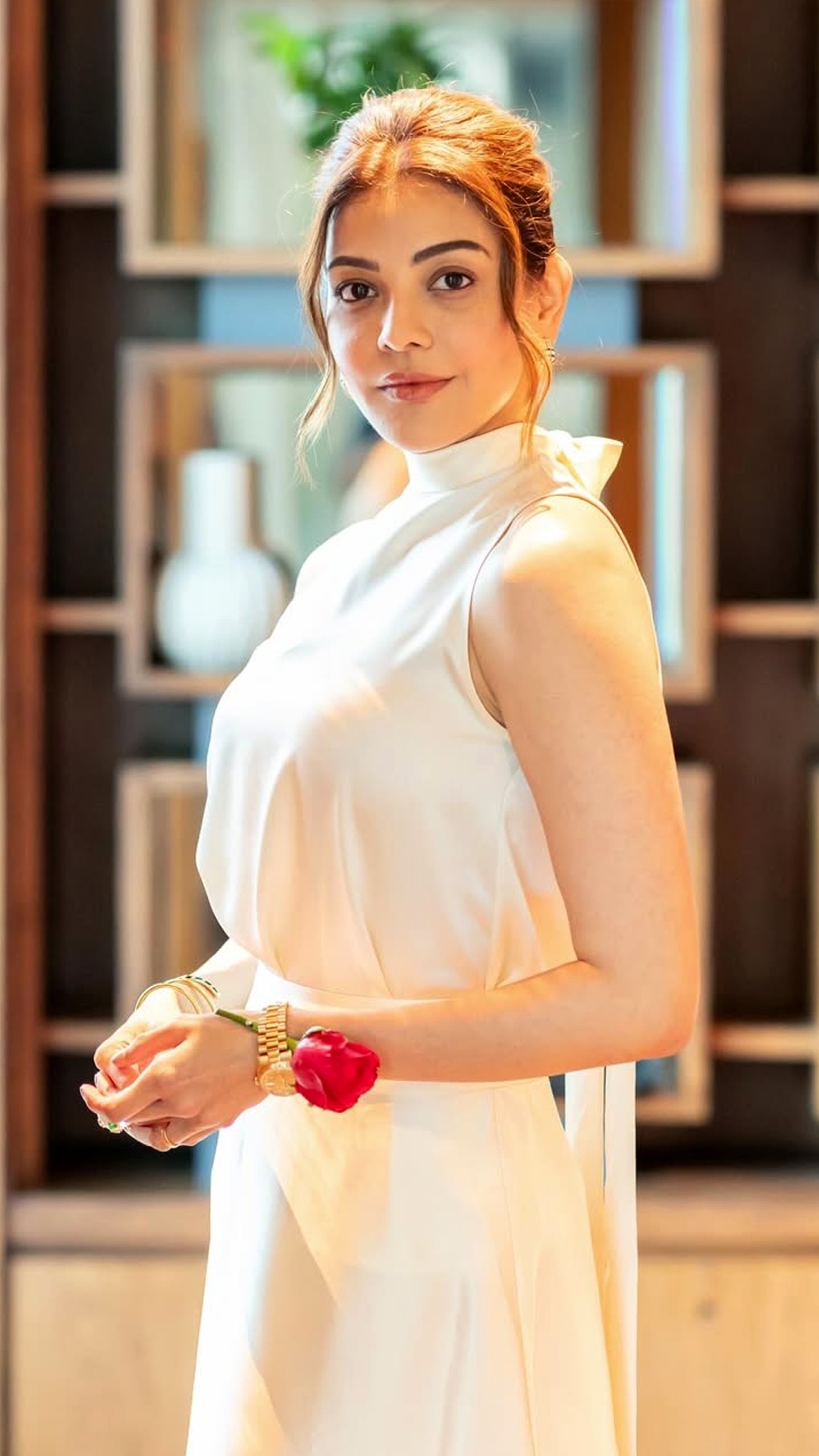 Kajal Aggarwal's Recent Photoshoot - The off-white top features a chic mock-neck design. Its satin finish catches the light beautifully while maintaining an effortless drape.