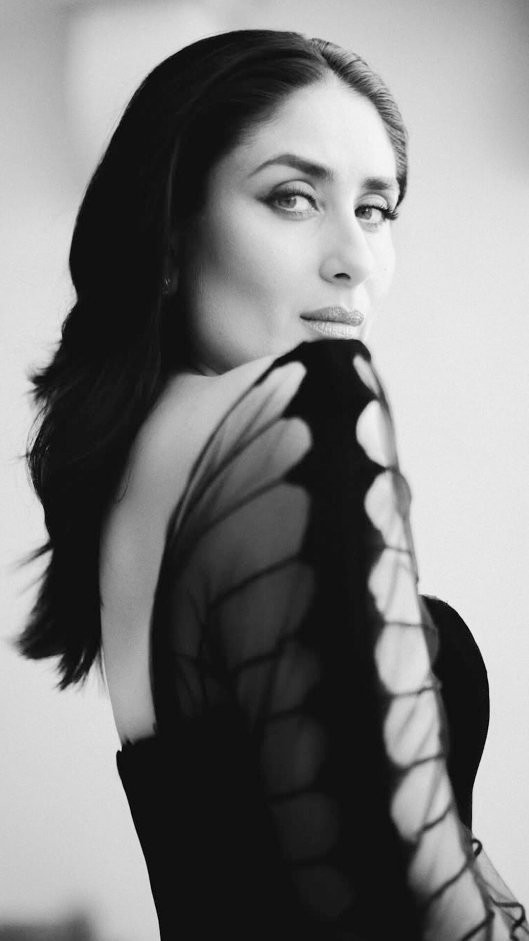 Kareena Kapoor's Recent Photoshoot - Her sheer black mesh sleeves with bold horizontal stripes add a touch of drama, creating a cage-like illusion that’s both structured and sensual.