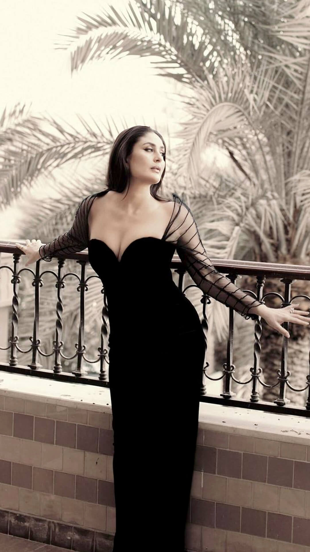 Kareena Kapoor's Recent Photoshoot - The off-shoulder neckline frames Kareena’s poise beautifully, balancing the opaque gown with sheer sleeves for a contrast that feels bold yet refined.