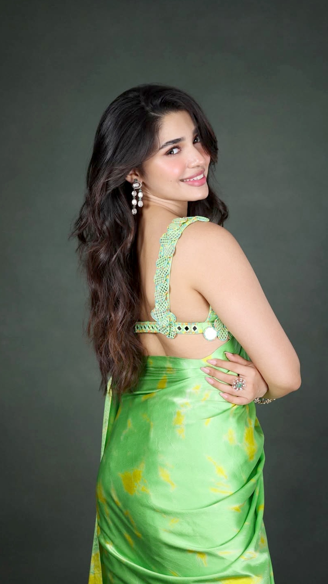 Krithi Shetty's Recent Photoshoot - Her blouse shines with neon green resham work, mirrors and beads, adding texture and sparkle that instantly lifts the entire outfit.