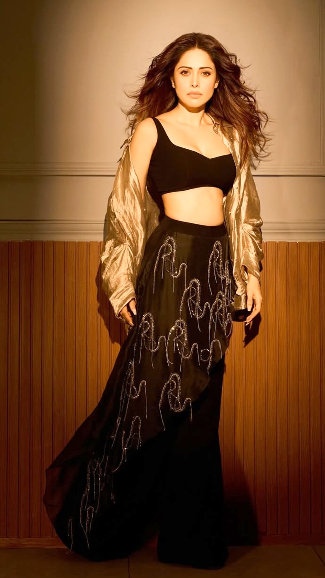 Nushrratt Bharuccha's Recent Photoshoot - Hairstylist Baljit Cheema went for a classic side part with soft, bouncy waves that give Nushrratt a truly effortless feel.