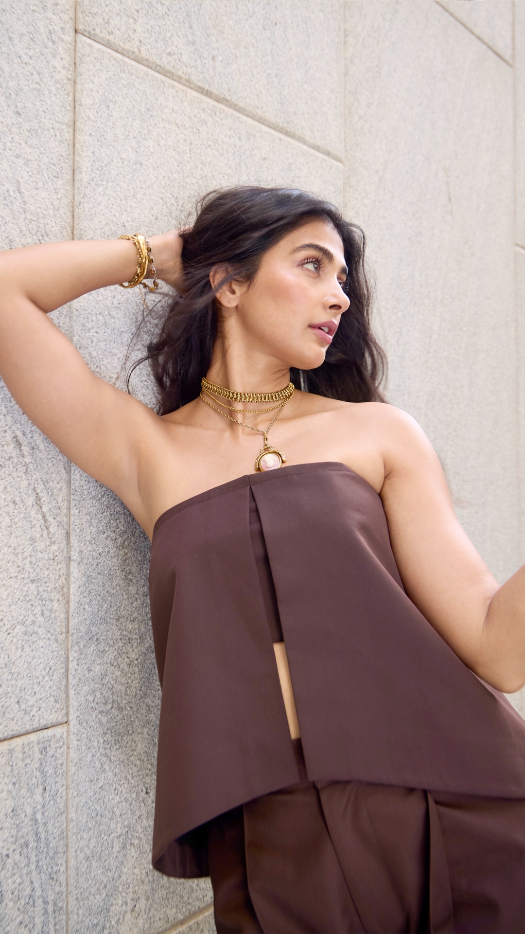 Pooja Hegde's Recent Photoshoot - The top stays uncluttered, with a straight neckline and a narrow front opening that breaks the surface without disturbing the minimal shape.