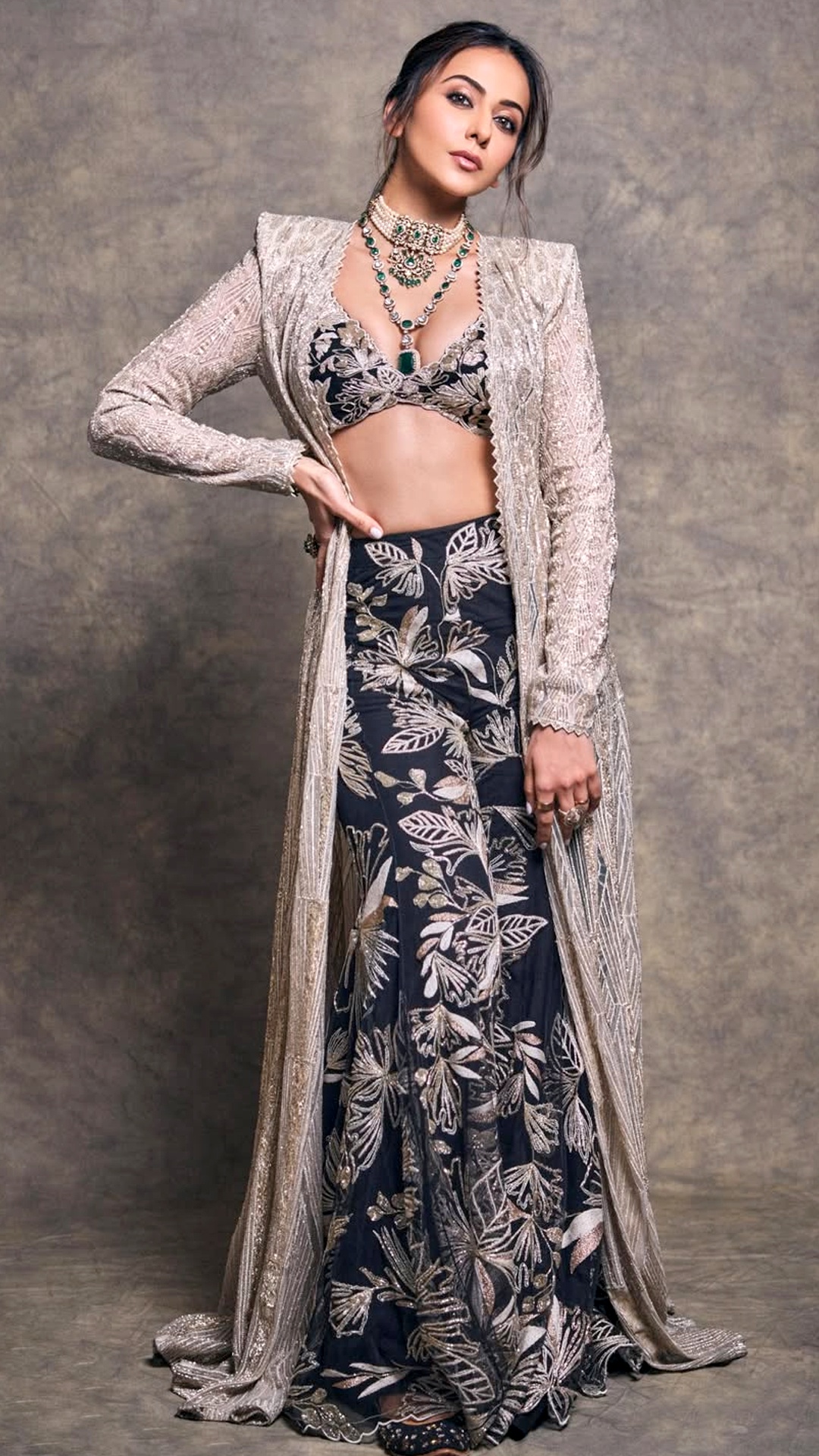 Rakul Preet Singh's Recent Photoshoot - Her floor-length fitted skirt flaunts fluid fabric adorned with dense gold botanical thread work.