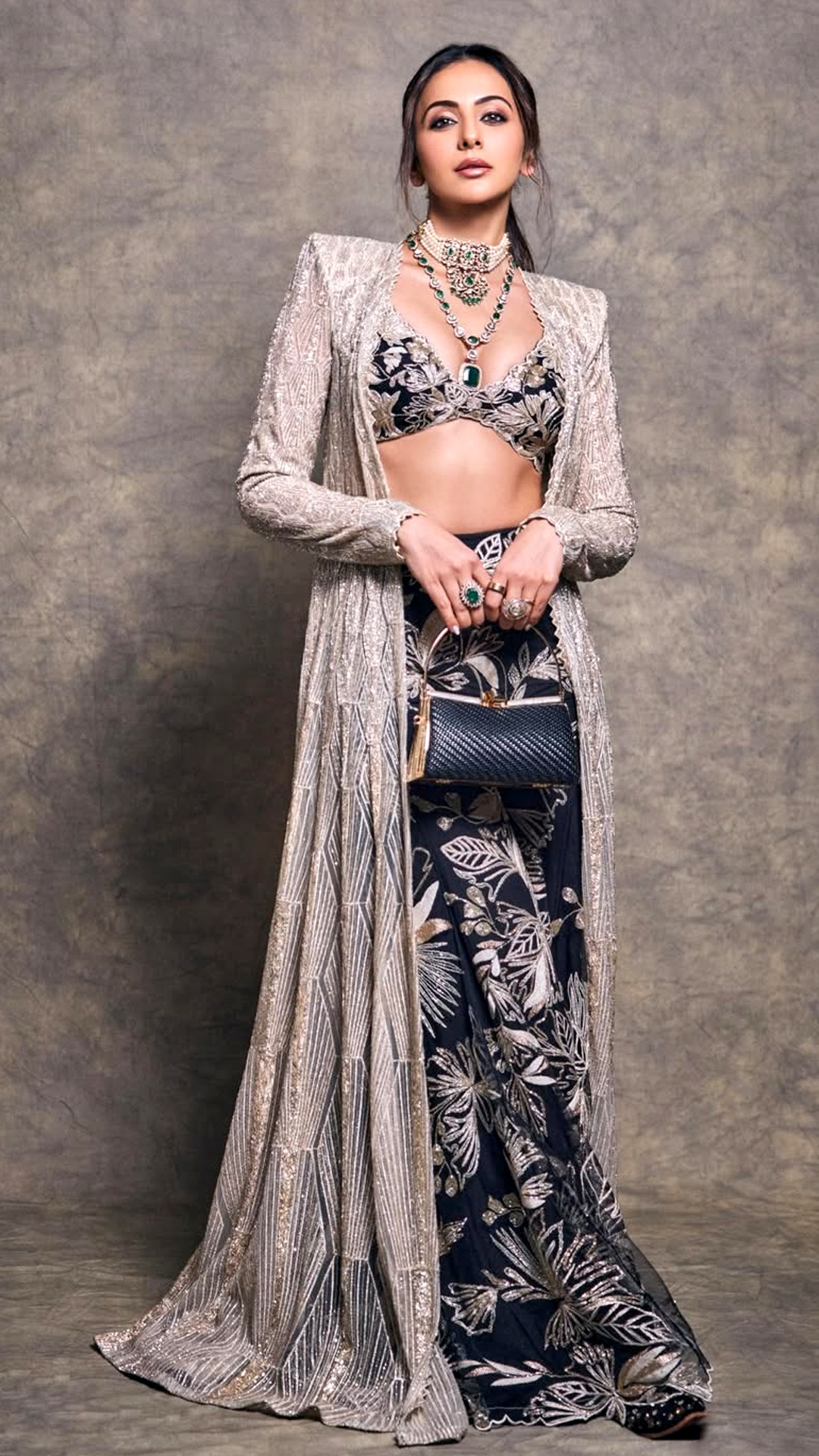 Rakul Preet Singh's Recent Photoshoot - She holds a structured black clutch by Fizzy Goblet, featuring a chic metallic clasp for extra drama.