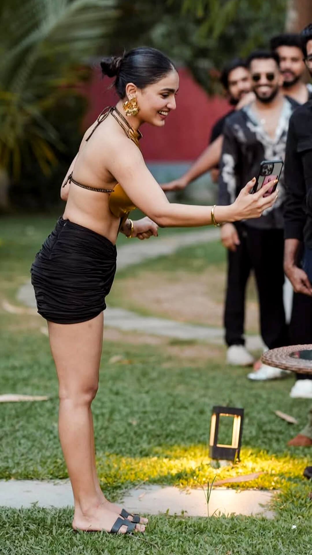 Saniya Iyappan's Recent Photoshoot - Saniya completes her birthday look with comfortable yet stylish black open-toe flat sandals featuring wide straps.