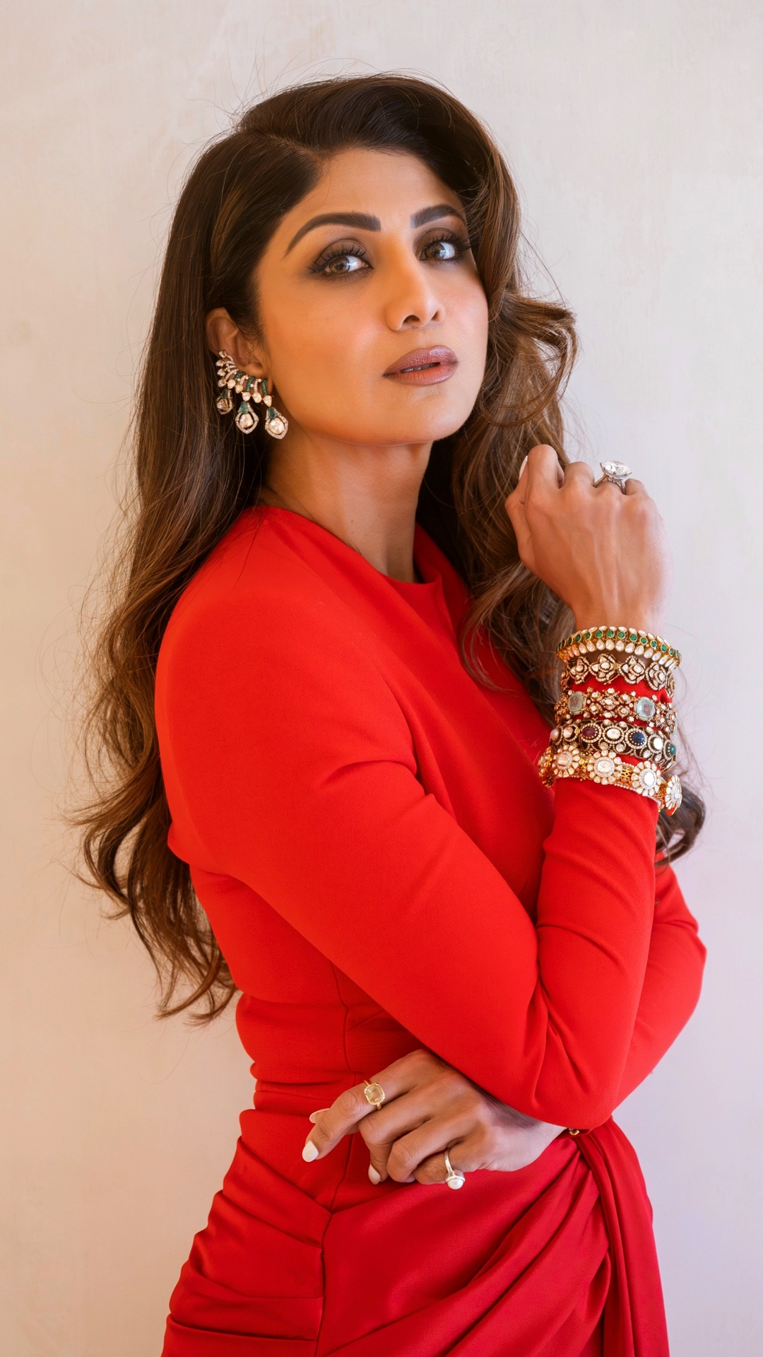 Shilpa Shetty's Recent Photoshoot - Long fitted sleeves and a closely tailored bodice keep the upper half visually restrained, directing attention towards the sculptural waist treatment.