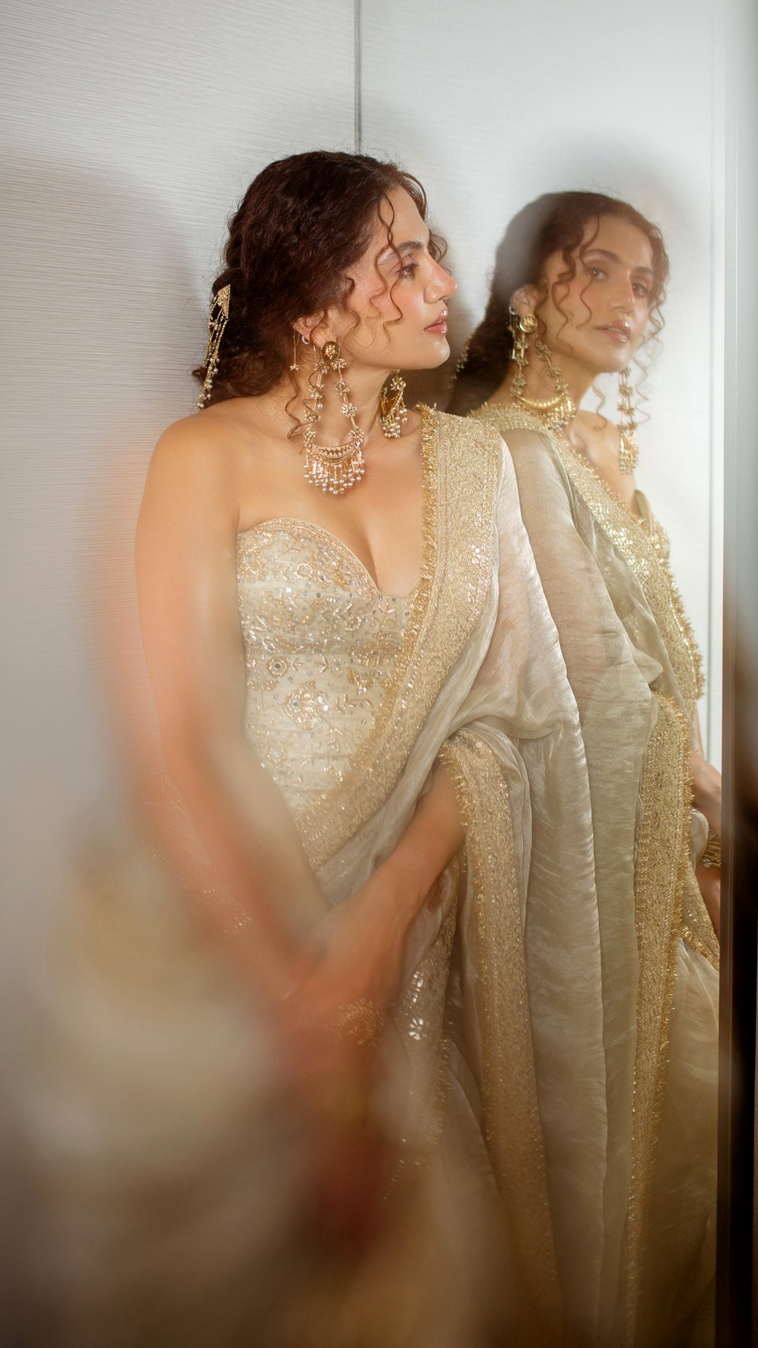 Taapsee Pannu's Recent Photoshoot - Hairstylist Seema Mane fashions Taapsee's natural curls into an elegant updo with soft tendrils that highlight the ornate drop earrings.
