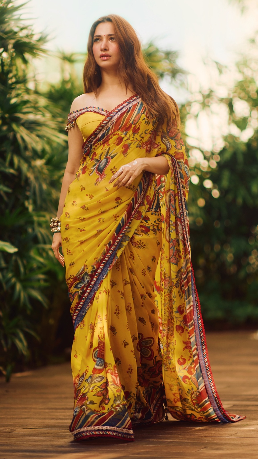 Tamannaah Bhatia's Recent Photoshoot - Makeup artist Sonam Chandna Sagar opts for a soft, dewy base, a red bindi and a glossy nude-pink lip that keeps focus on the outfit's colour.