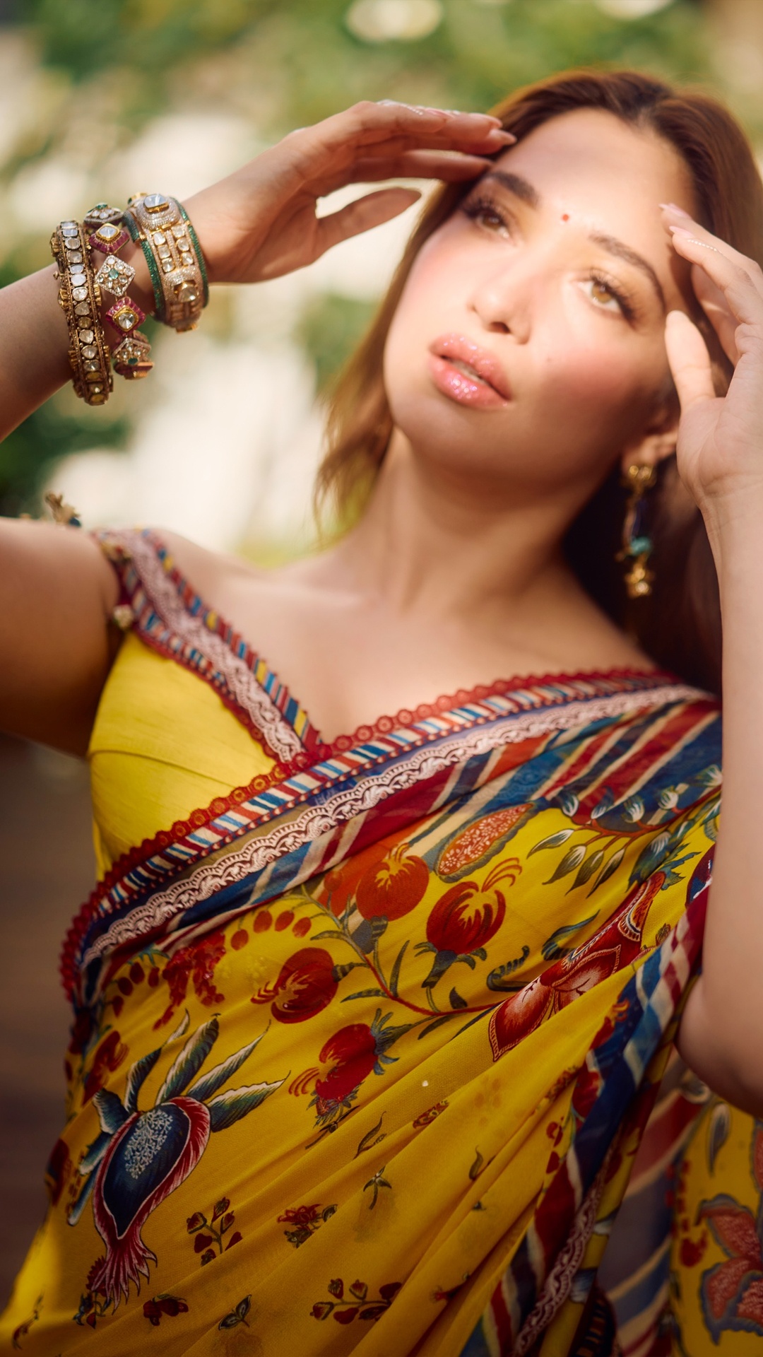 Tamannaah Bhatia's Recent Photoshoot - The floral earrings and the multiple stacked bangles come from jewellery houses Sunita Shekhawat and Mahesh Notandass.